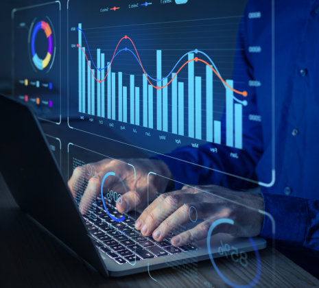 Data analyst working on business analytics dashboard with charts